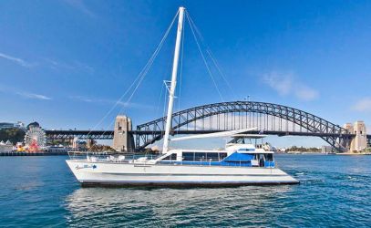 Boat Hire on Aussie Magic passing the Sydney Harbour Bridge