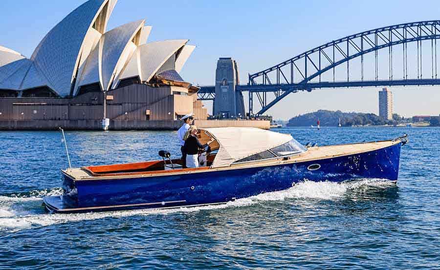 Boat Hire on Something Blue in front of the Sydney Harbour Bridge and Sydney Opera House 