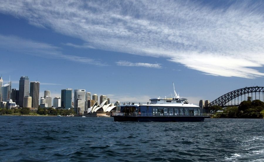 Boat hire Bella Vista passing by Sydney Harbour bridge Boat hire Bella Vista passing by Sydney Harbour bridge