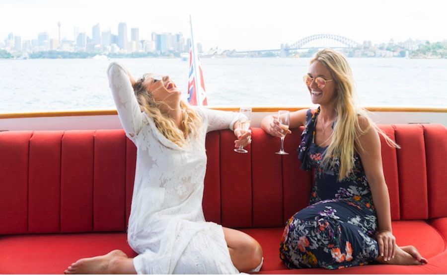 Boat hire on MV Baroness aft deck lounge with city background