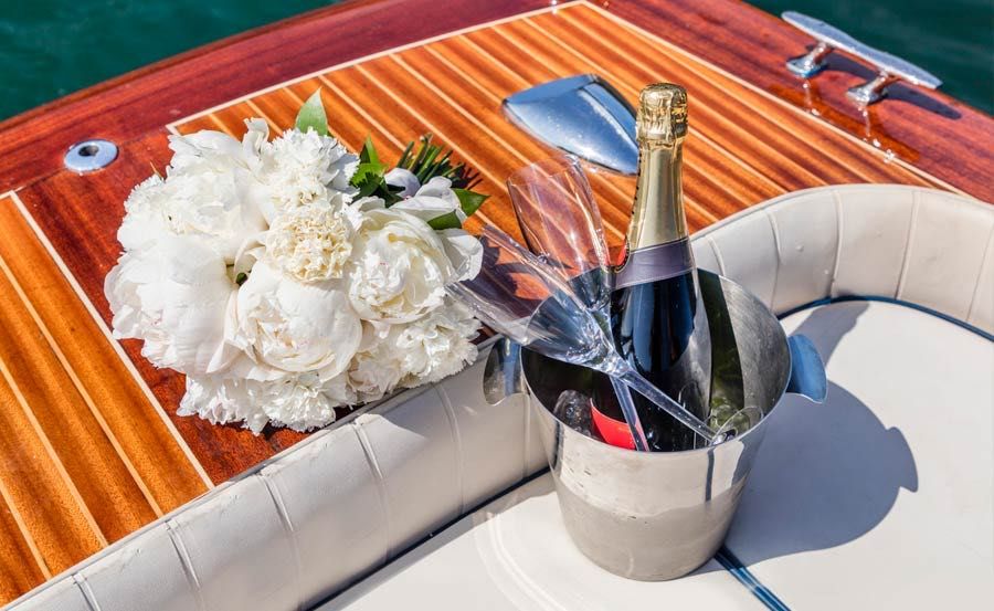 Luxury Italian Wooden Speedboat Cruises in New South Wales with a bunch of flowers and bucket of sparkling wine Luxury Italian Wooden Speedboat Cruises in New South Wales with a bunch of flowers and bucket of sparkling wine