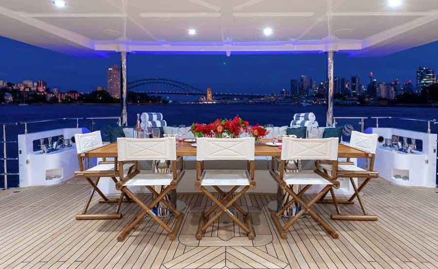 Whitsundays Super Yacht Hire on ONEWORLD Lower deck on with dining arrangement on stern Whitsundays Super Yacht Hire on ONEWORLD Lower deck on with dining arrangement on stern